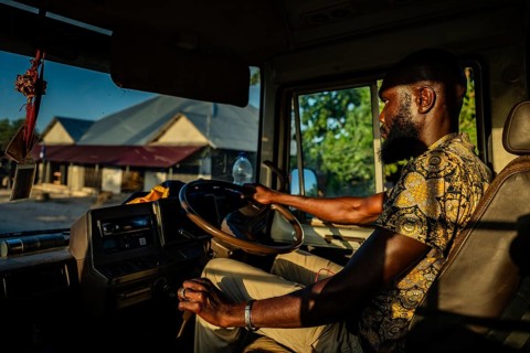 PAJE, ZANZIBAR - OCTOBER 18, 2025: A local African man driving a bus through a Zanzibar village,