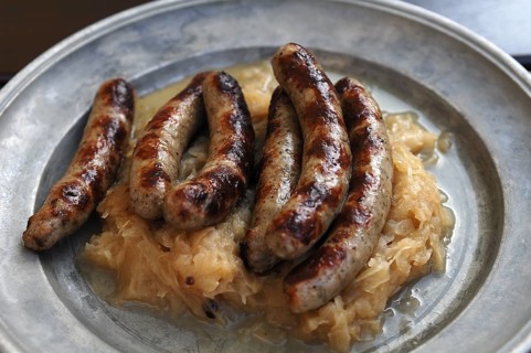 Six Nuremberg bratwurst with cabbage served on a tin plate, Nuremberg, Middle Franconia, Bavaria,