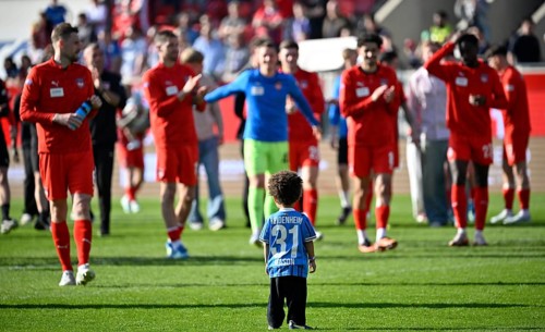 Players of 1. FC Heidenheim celebrate after the final whistle, in front little son Mason of Sirlod