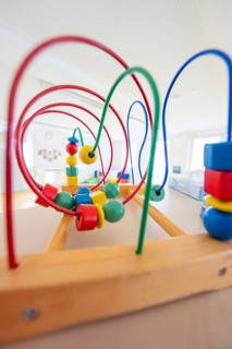 Detail of a wooden toy with colorful beads and wires in a room, children's house, Calw, Germany