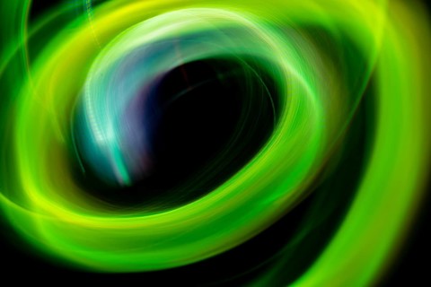 A dynamic swirl of vibrant green neon lights creating an abstract, ethereal pattern, captured using