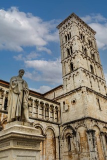 Statue of the Italian politician Francesco Burlamacci, behind the bell tower of the church of San