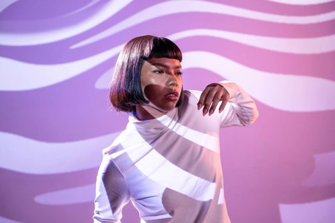 A futuristic Latin woman engages with the metaverse, surrounded by a captivating digital