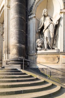 Sandstone figure of St Mark the Apostle with a lion on the outer façade of the Hofkirche, Dresden,