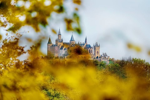 Castle and autumnal forest, Hohenzollern Castle, Hechingen, Swabian Jura, Baden-Württemberg,