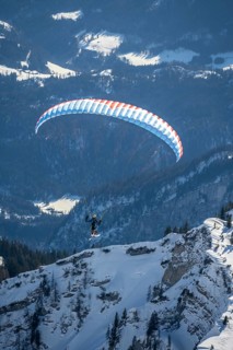 Mountains in winter, paraglider with skis on Sonntagshorn, Chiemgau Alps, Bavaria, Germany