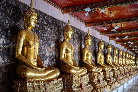 Bangkok, Thailand. February 20th 2025. A row of Golden Buddhist statues in a pavilion at the The