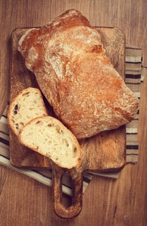 Sliced ciabatta, on a chopping board, italian bread, close-up, Italian cuisine, breakfast, no