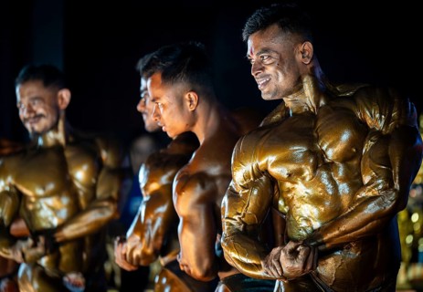Male bodybuilding competitors flex their muscles as they compete during the 36th Mr Saraighat all