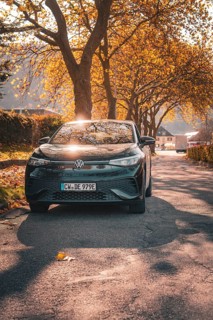 Car in the sunlight on a tree-lined road, electric car VW ID5, Deer Carsharing, Gechingen, Black