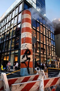 Steaming chimney at a construction site behind a high-rise building, New York City, USA
