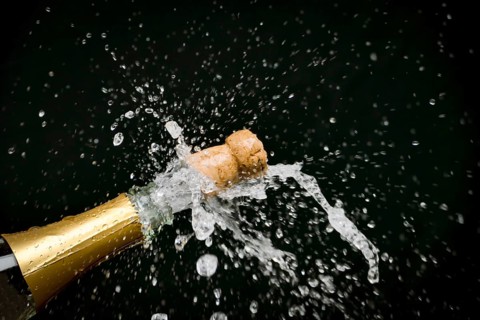 A champagne bottle is opened, sparkling wine, champagne cork flies out, champagne, celebration, New