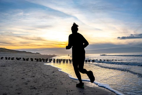 Winter on the North Sea, sunset at the beach, joggers, beach walkers, coastal protection, through