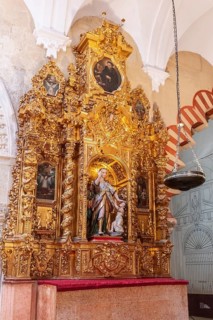 Gilded altar with figure of a saint and baroque decorations, symbolic, Cordoba