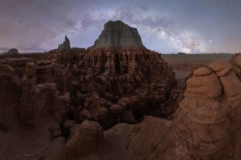 A mesmerizing panorama showing the Milky Way arcing above the unique rock formations of Goblin