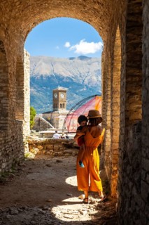 A woman with her son walking in the arches of the fortress of the Ottoman castle of Gjirokaster or