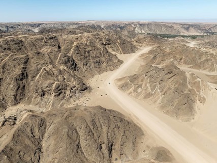 Aerial view, dry barren mountains in Moon Valley, rocky landscape ridged by erosion, Namib-Naukluft