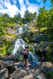 A hiker enjoying the summer at the Todtnau waterfall in the Black Forest in Germany