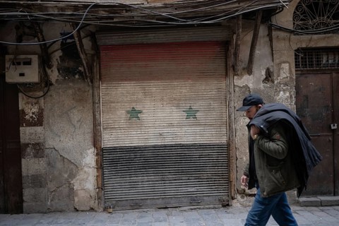 Damascus, Syria. December 5th 2025. A closed shuttered shop painted with the color of the Assad