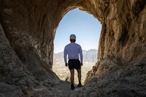 A man takes a break while mountaineering and rappelling at Eagle's Nest, Monterrey, Mexico,