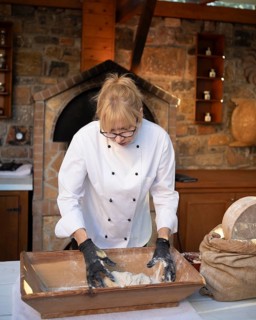 Greek woman baking Greek olive bread, Laconia, Peloponnese, Greece