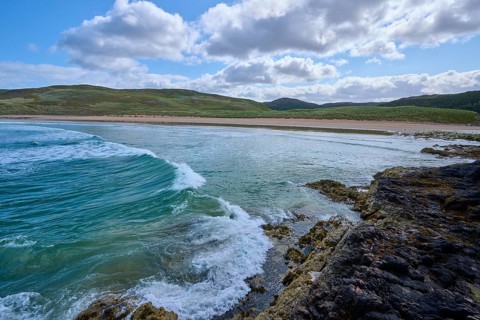 Waves break on a rocky coast under a mostly cloudy sky, Farr Bay, Bettyhill, Thurso, Scotland,