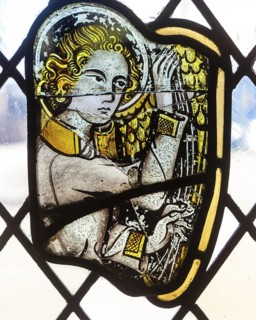 Stained glass window depiction of medieval man face, Bristol cathedral church, Bristol, England, UK