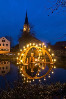 Floating double candle arch from the Ore Mountains with model of the church on the village pond,