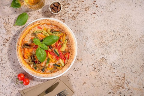 A delicious vegetarian pizza topped with vibrant zucchini, eggplant, and peppers, finished with