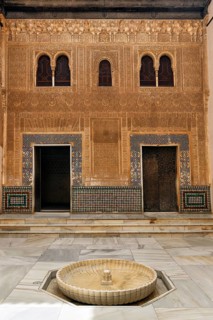 Patio del Cuarto Dorado, arabesque Moorish architecture, arched windows and fountains, Nasrid