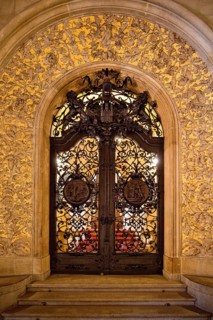 The golden-framed lattice gate to the Senate Staircase, City Hall, Hamburg, Germany