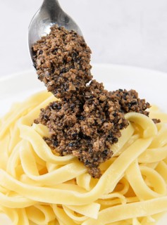 Tagliatelle pasta with chopped black truffle. Fresh Italian autumn recipe with black truffle on