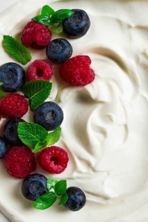 Breakfast, yogurt with fresh berries, raspberries and blueberries, on a white background, selective