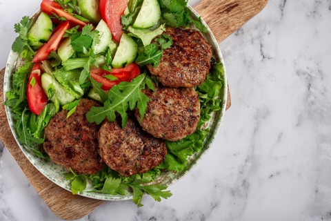 Fried cutlets, mixed minced meat, with vegetable salad, homemade, top view, no people