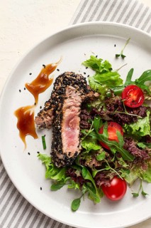 Vegetable salad, with fried tuna, in sesame seeds, healthy food, top view
