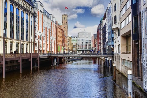 City view with a canal lined with modern and historic buildings, bridge in the foreground, Hamburg,