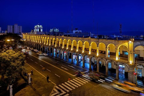 Illuminated arcades at night, flowing traffic with tracks, urban nightlife, The arcades at Plaza de