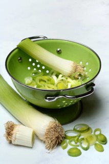 Leek, leek sticks and leek rings in a sieve bowl