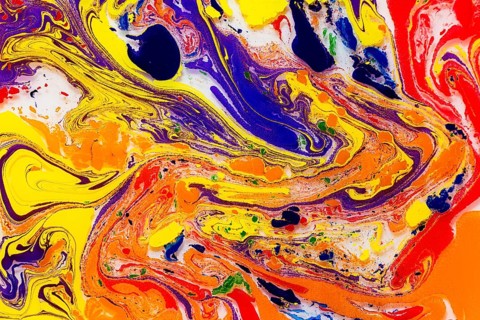 An eye-catching abstract image featuring intense swirls of red, yellow, blue, and orange, blended