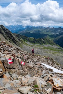 Red and white trail markings, hiker in the high mountains, Lasörling High Trail, Lasörling High