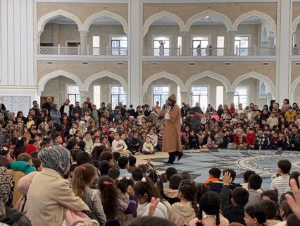 Dozens of Muslim children participate in indoor entertainment event inside a grand mosque during