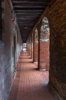 Arcade with brick columns in the old town, Venice, Veneto, Italy