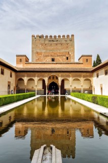 Myrtle courtyard with water basin and Torre de Comares, arabesque Moorish architecture, Nasrid