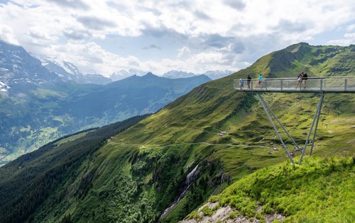 Tourists on the First Cliff Walk, metal trail on a rocky outcrop, Grindelwald First, in front of