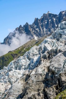 Glacier ice of the Glacier des Bossons, behind pointed mountain peaks, Chamonix, Haute-Savoie,