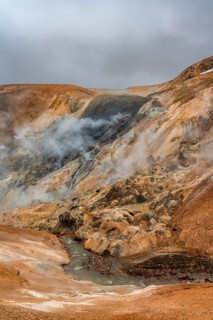 Steaming stream between colourful rhyolite mountains, Hveradalir geothermal area, Kerlingarfjöll,