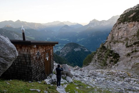 Hikers early in the morning at the practice bivouac, a bivouac box in the Loferer Steinberge,