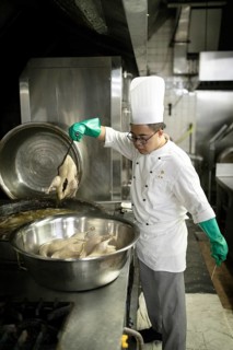 An assistant chef cooks salt ducks at the Mei Yuan restaurant in the Jinlin Hotel, Nanjing, China