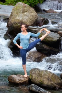 Yoga outdoors, woman doing Ashtanga Vinyasa Yoga balance asana Utthita Hasta Padangushthasana,