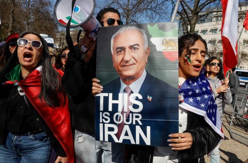An Iranian woman wears a picture of Prince Reza Pahlavi with the inscription This is our Iran